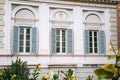 European windows with wooden shutters. Old house exterior. Royalty Free Stock Photo