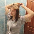 European woman apply hair curlers on hair