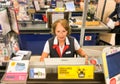 European woman cashier working at the cash desk inside a Maxima supermarket in Riga, Latvia Royalty Free Stock Photo