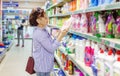 European woman customer buying detergents home appliances cosmetics for laundry in shopping mall