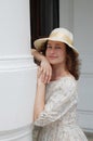 European woman with hat in vintage dress near palace. Royalty Free Stock Photo