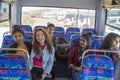 European woman having trip by the bus together with four asian women