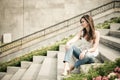 european woman sitting on steps