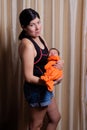 European young brunette mother holding her newborn baby son in her hands Royalty Free Stock Photo