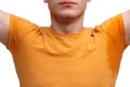 A guy dressed in an T-shirt, raised hands with wet sweaty armpits. Close-up. Isolated on white. Royalty Free Stock Photo