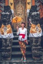 European young woman in balinese traditional temple. Bali island.