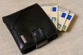 5 euros in a black leather wallet on a gray background Royalty Free Stock Photo