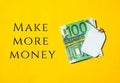Euros cash money and paper note with text written MAKE MORE MONEY. Concept of financial planning. Make more extra money from Royalty Free Stock Photo