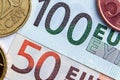 50 and 100 euros close-up. Euro cents are located on the sides. investment concept