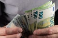 100 Euros and 100 dollars banknotes in men hands. Close up Royalty Free Stock Photo