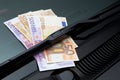 Euros under windshield wiper Royalty Free Stock Photo