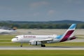 Eurowings Europe Airbus A319-132 with the aircraft registration OE-LYX is landing on the southern runway 26L of the Munich Airport