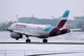 Eurowings plane taking off from snowy runway