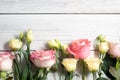 eustoma flowers and pink roses on wooden background in vintage style. Romantic wedding background. View from above