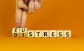 Eustress or distress symbol. Psychologist turns cubes and changes the concept word Eustress to Distress. Beautiful orange table