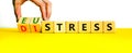 Eustress or distress symbol. Psychologist turns cubes and changes the concept word Eustress to Distress. Beautiful yellow table