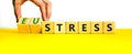 Eustress or stress symbol. Psychologist turns cubes and changes the concept word Eustress to Stress. Beautiful yellow table white