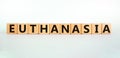 Euthanasia symbol. Wooden cubes with the word `Euthanasia`. Medical and euthanasia concept. Beautiful white background, copy spa Royalty Free Stock Photo