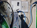 EV Car or Electric vehicle at charging station with the power cable supply plugged in on blurred nature with blue enegy Royalty Free Stock Photo