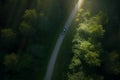 EV car on road going through forest. eco friendly cars. high angle shot.