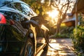 EV charging car on a sunny summer day ourside his garage. Generative AI Royalty Free Stock Photo