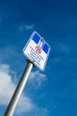 EV - electric vehicle charging station sign on blue sky background Royalty Free Stock Photo