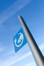 EV - electric vehicle quick charging station sign on blue sky background Royalty Free Stock Photo