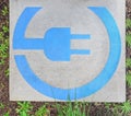 EV - electric vehicle quick charging station sign surrounded by green leaves Royalty Free Stock Photo