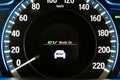 EV- Electrical vehicle mode turned on on hybrid car screen in front of steering wheel for green power fuel transportation