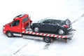 Evacuation of a broken car in cold winter. In winter, a tow truck takes the car away after an accident. Car assistance in winter Royalty Free Stock Photo