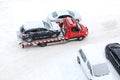 Evacuation of a broken car in cold winter. In winter, a tow truck takes the car away after an accident. Car assistance in winter Royalty Free Stock Photo