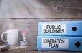 Evacuation plan and public buildings. Two binders on desk in the office Royalty Free Stock Photo