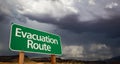 Evacuation Route Green Road Sign and Stormy Clouds Royalty Free Stock Photo