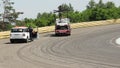 Evacuator removes broken racing auto from track, crew leave road