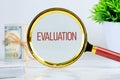 EVALUATION text showed through a magnifying glass on a light background. Customer Satisfaction Survey Concept Royalty Free Stock Photo