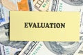 EVALUATION text written on yellow paper on the background of banknotes. Customer Satisfaction Survey Concept Royalty Free Stock Photo
