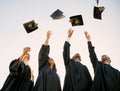 Even if its tough, you can still triumph. a group of students throwing their hats in the air on graduation day.