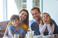 Even mealtime is a chance for quality time. Portrait of a family enjoying a meal together at home. Royalty Free Stock Photo