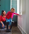 Even princesses need rain boots. Full length shot of a mother watching her daughter try on a pair of large rain boots at