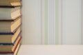 A neat stack of books on the edge of the white table Royalty Free Stock Photo