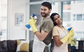 Even Superman and Superwoman do chores. a happy young couple getting ready to disinfectant their home.