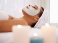 Even when young, every little bit helps...a young woman enjoying a facial treatment at a spa. Royalty Free Stock Photo