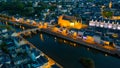 Evening aerial view of Laval with buildings, river Mayenne and old bridge