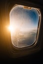 Evening airplane flight in twilight sky. Sunset view in cabin frozen window frame