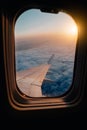 Evening airplane flight in twilight sky. Sunset view in cabin frozen window frame