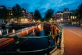 Evening in Amsterdam city, light trails and reflections on water at the Leidsegracht and Keizersgracht canals. Long