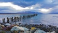 Evening atmosphere with birds and dramatic clouds at the jetty near Puerto Natales, southern Chile Royalty Free Stock Photo