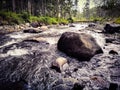 evening atmosphere in the river flow with the appearance of a large rock