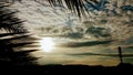 Evening beautiful cloudy sunset view with palm leaves Royalty Free Stock Photo