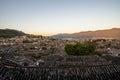 Evening bird eye view of local historical architecture roof building of Old Town of Lijiang in Yunnan, China. Royalty Free Stock Photo